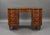For sale is a good quality mahogany and chequer banded kidney shaped desk by Wolfe & Hollander, having an inset green...