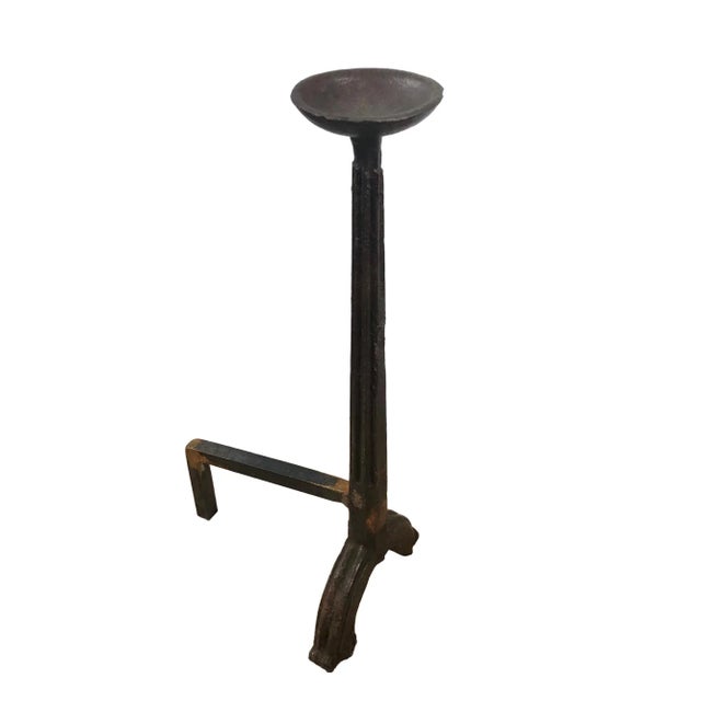 A fine and rare 17th Century pair of tall forged iron andirons. The andirons are single column with a cupped top on a...