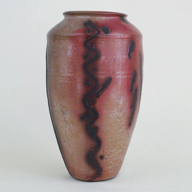 Tall modern raku pottery vase dated 1987 by noted ceramic artist Tom Radca (b. 1951). This unique studio piece is incised...