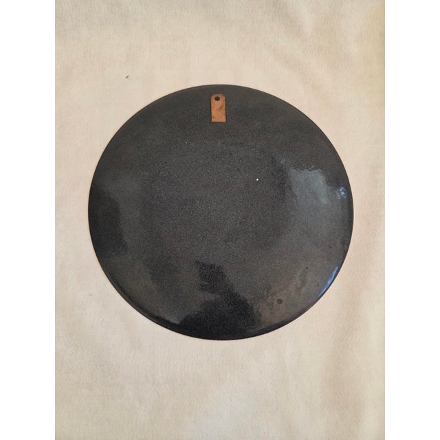 Large Mid-Century Enameled Copper Wall Plate. Features a guilded grape motif on green background. Has welded hanger on...