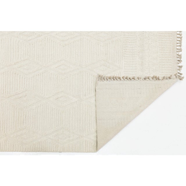 Elevate your space with the understated elegance of this Modern Moroccan-style area rug. Hand-woven from premium wool, it...