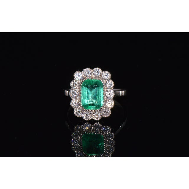 Gorgeous 18K solid gold 3.10CTS diamond and emerald ring. This ring features a beautifully crafted halo design with a...