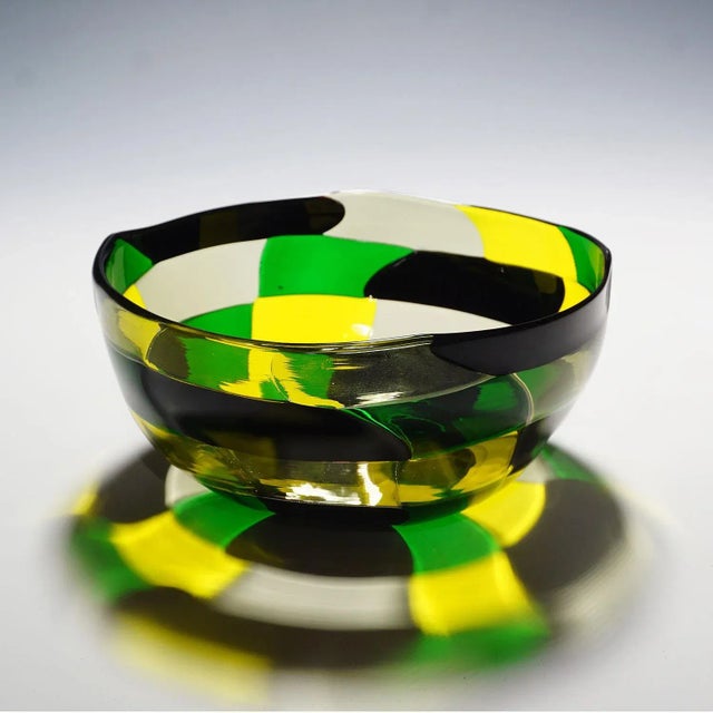 A Pezzato Americano bowl in yellow, green, straw and black colored glass designed by Fulvio Bianconi in 1950. Manufactured...