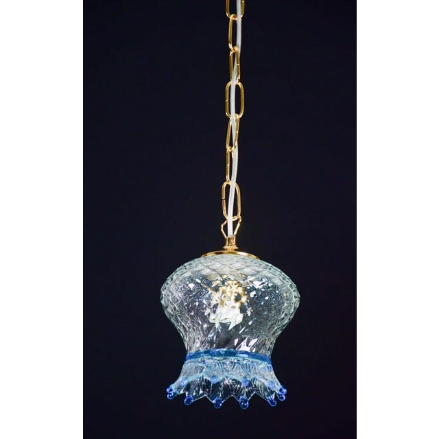 Set of 5 blue and transparent Murano glass pendants. The 5 pendants are formed by the glass and the chain in new gold...