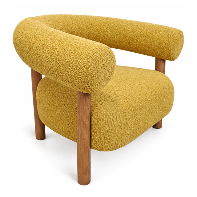 Modern unique mustard yellow poly upholstered accent chair. U-back design with sleek cylindrical oak wood post legs. Seat...