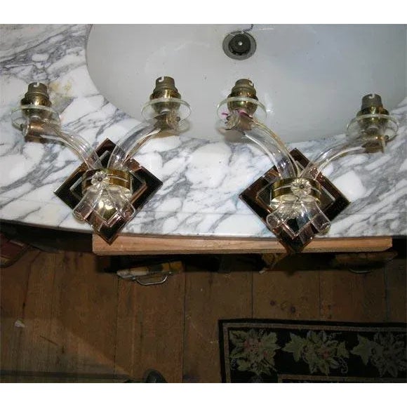 Pair of small pink mirror and clear mirror back sconces with blown glass arms and lucite bobeches.