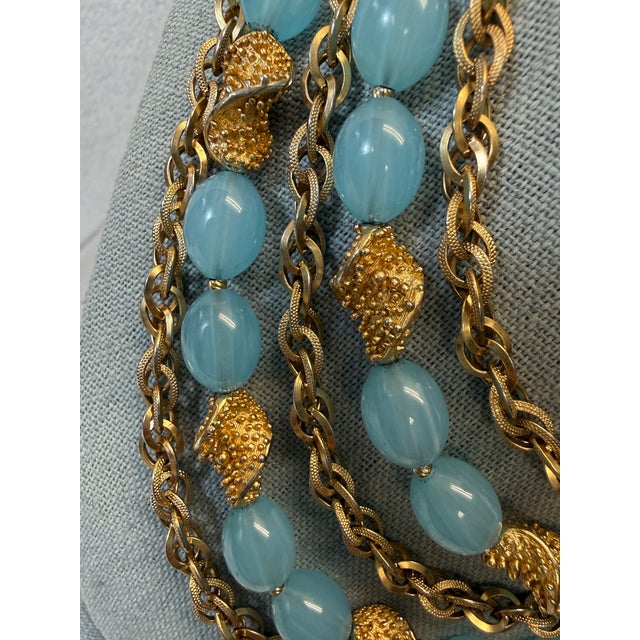 Vintage crown Trifari Etruscan necklace and earrings set, signed. Aqua lucite includes clip earrings and 4 strand necklace...