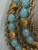 Vintage crown Trifari Etruscan necklace and earrings set, signed. Aqua lucite includes clip earrings and 4 strand necklace...