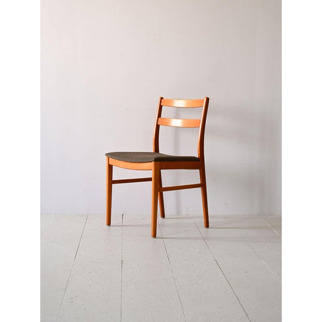 Original vintage chairs with padded seat. The wooden structure has a backrest formed by two slightly curved horizontal...