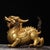 This is a finely crafted antique gilt bronze sculpture of a mythical beast, possibly a stylized Qilin or a similar revered...