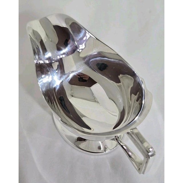 A George V sterling silver sauce or gravy boat by Cooper Brothers & Sons Ltd, hallmarked Sheffield 1936. Dating from the...