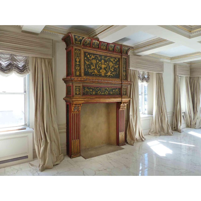 Antique, turn of the century oversized Italian Mediterranean fireplace mantel decorated with carvings and ornamental gold...