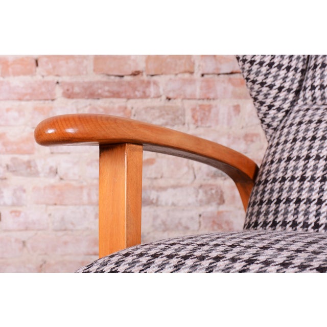 This elegant wingback armchair (known as "ušák") is a prime example of Czechoslovak design from the 1940s. Its form sits...