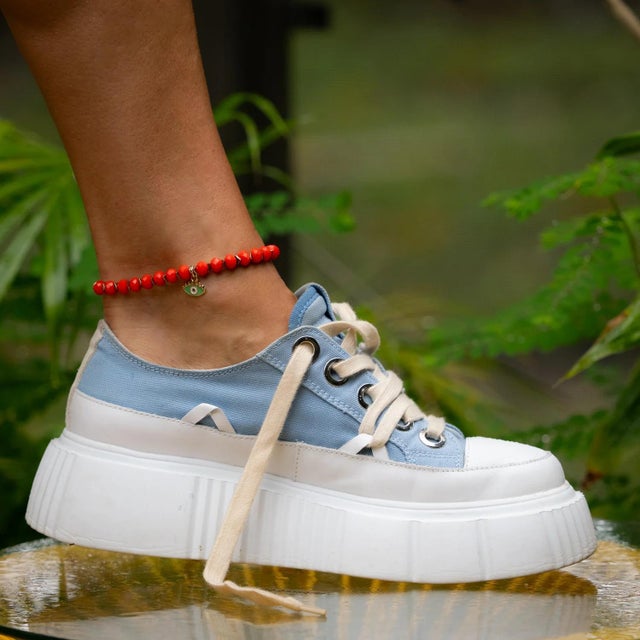 Ignite your energy and ward off negativity with the Red Flame & Green Gaze Evil Eye Beaded Anklet. This bold and...