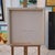 This artwork presents a striking study of the human form from a rear perspective, capturing the subject with profound...