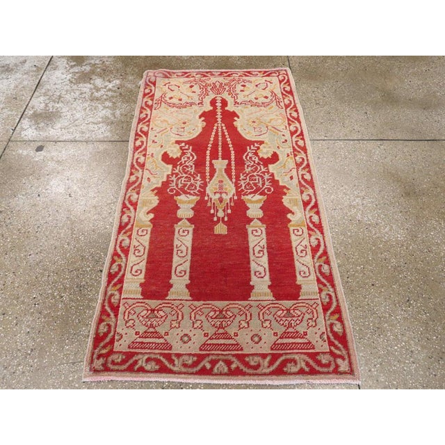 An antique Turkish Oushak throw rug. A scarlet Rococo tall niche is supported by side pilasters and there are two...