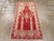 An antique Turkish Oushak throw rug. A scarlet Rococo tall niche is supported by side pilasters and there are two...