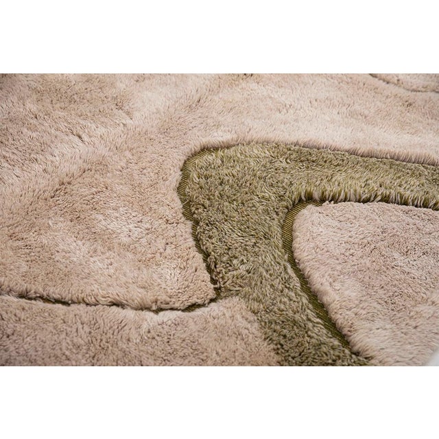One-of-a-kind hand-knotted wool area rug in light taupe and olive green, featuring an abstract composition with flowing...
