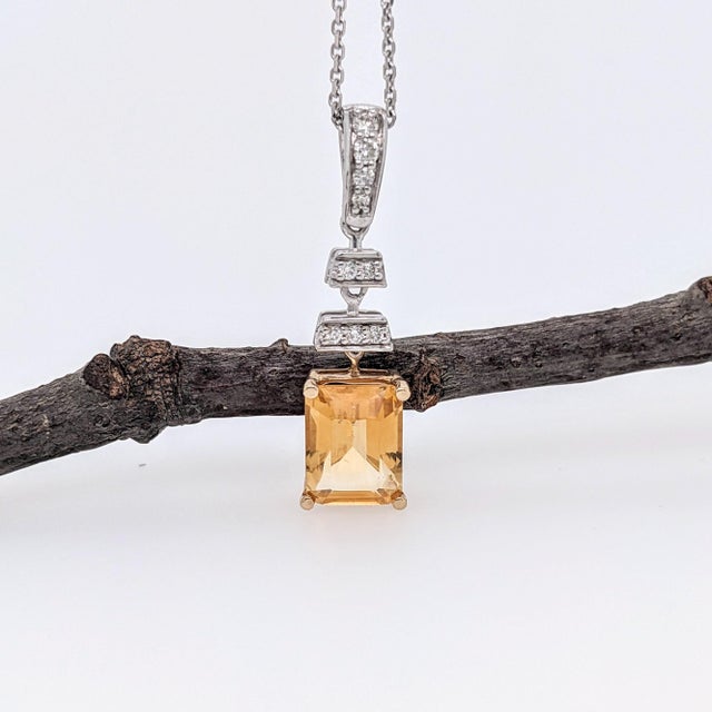 This beautiful pendant features a sparkling 1.22 carat emerald cut citrine with natural earth mined diamonds set in solid...