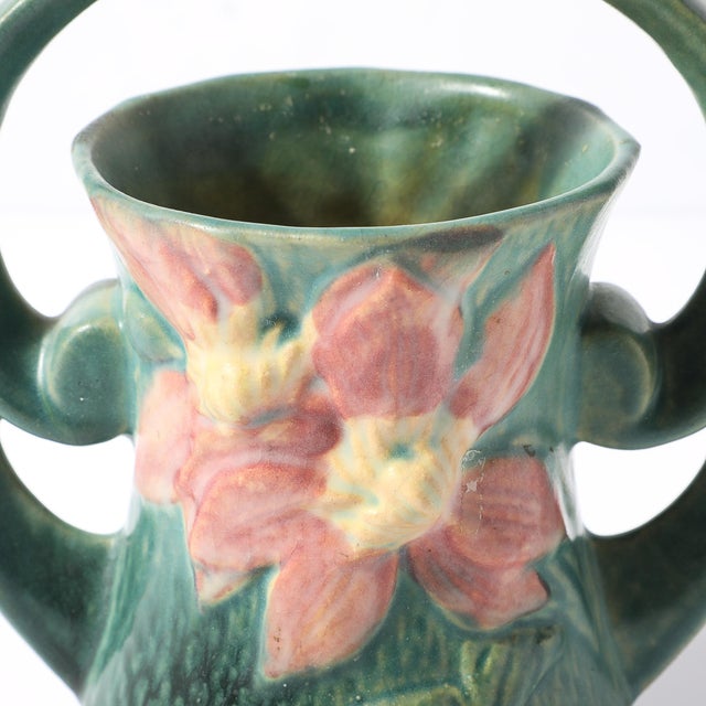 This vintage ceramic vase / basket, crafted by Roseville Pottery in circa 1944, is a beautiful example of the Art Deco...