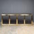 A large mirrored credenza / sideboard designed by Michel Pigneres, with four brass and chrome cupboard doors with mirrored...