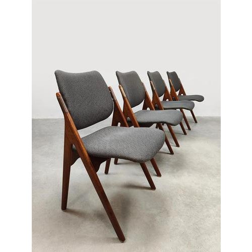 This set of four vintage Scandinavian dining chairs, designed by Olav Houg, is a little bit different. This set is...