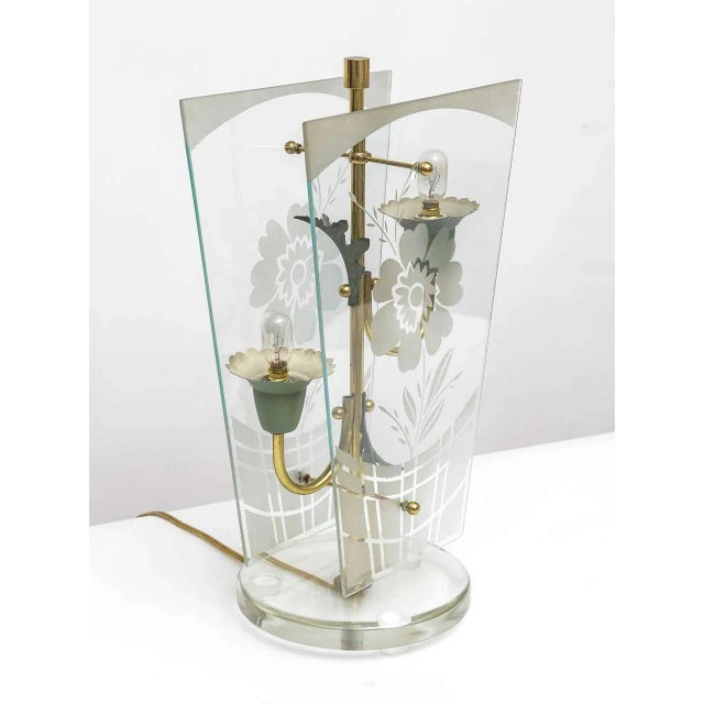 Very early Fontana Arte table lamp. Floral arrangement in brass tube and zinc lamp sockets, flanked by two glass-plates...