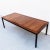 Exceptional mid century modern Parsons style walnut dining table with rosewood border and black-lacquered legs, produced...