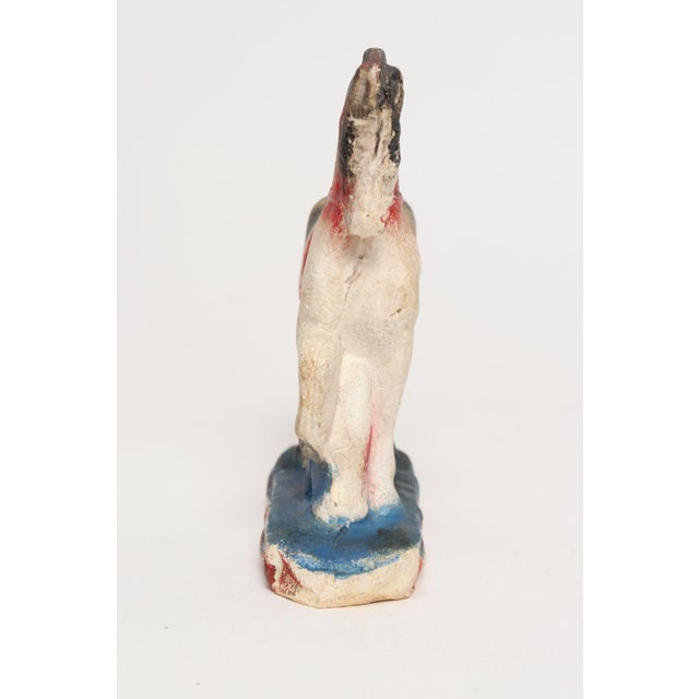 Circa 1920s/30s Americana painted chalkware horse in patriotic palette of red, blue, and cream/white with black accents....