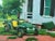 This is an original, signed and dated, oil painting of a green tractor in front of the white, big house, painted on...