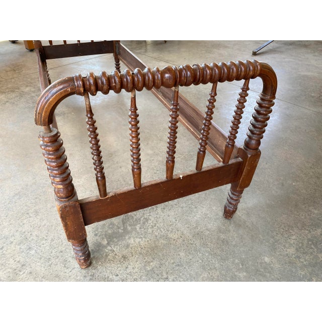 Antique bed frame, in need of restoration, but sturdy and well suited for a small space. Mattress size 27.5 by 71.5.