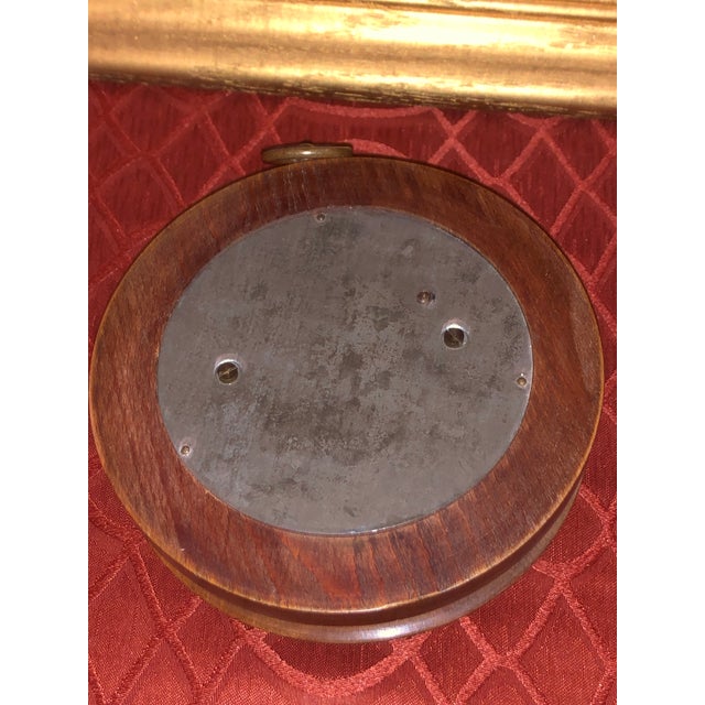An exceptional French late-19th-century aneroid wall barometer housed in a substantial, deeply turned wood "pocket watch"...