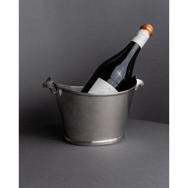 This vintage silver-plated champagne cooler from the 1940s features a classic, refined form designed to elevate your bar...