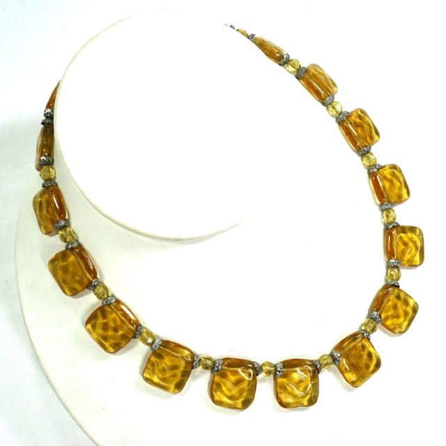 1920s Czech citrine art glass necklace. Flat lozenges of amber-hued citrine glass are bordered with tiny fluted silver-...