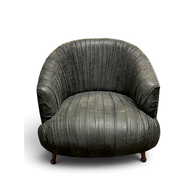 Stunning rouched blue gray leather lounge chair complete with walnut legs. Great to curl up and read a book! It has a firm...
