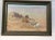 This is an unusual antique painting of the remains of a wagon and animal with mountains in the background. It is signed...