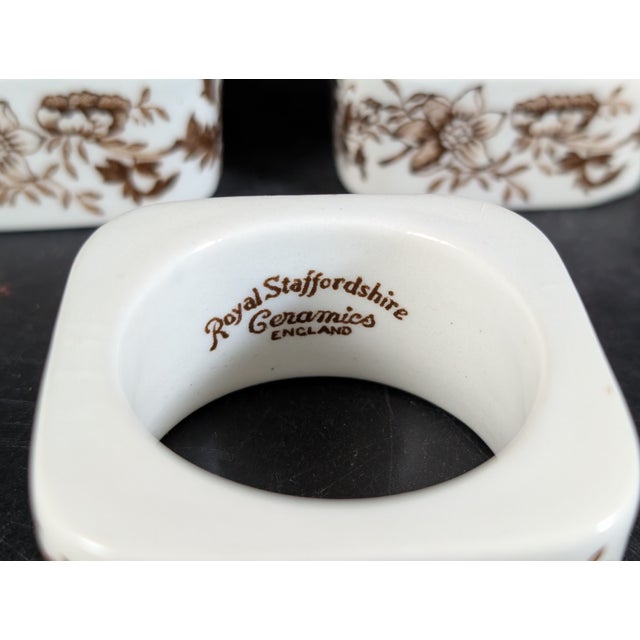 Set of three rare Tonquin brown napkin rings by Royal Staffordshire. 1.5 inch opening, 2 7/8 total diameter. Minor...