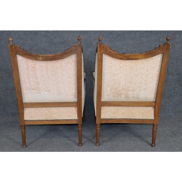 Dimensions- H: 42in W: 27 1/2in D: 27 1/4in SH: 20 1/2in A refined and exceptionally comfortable pair of antique French...