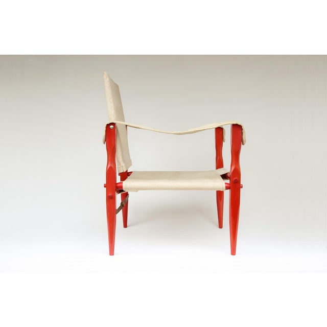 "Safari" armchair, made in Germany in the 1960s/70s. Red-stained beechwood, durable cotton fabric. Age-related patina,...