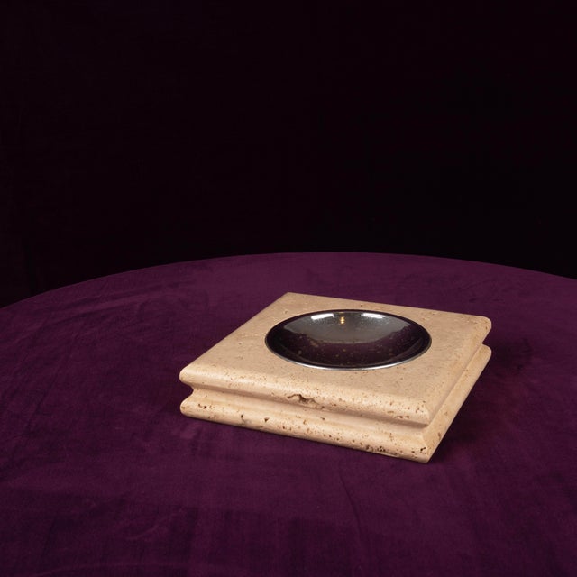 Overview A bold square ashtray in warm Italian travertine, 1970s, fitted with a removable polished metal dish. A solid,...