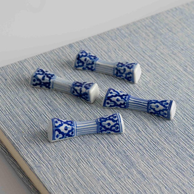 Charming set of four vintage porcelain chopstick or knife rests in a classic blue and white pattern. Each piece is...