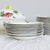 A charming set of twenty-eight pieces by Villeroy & Boch in the “Bouquet” pattern of colorful floral illustrations on...