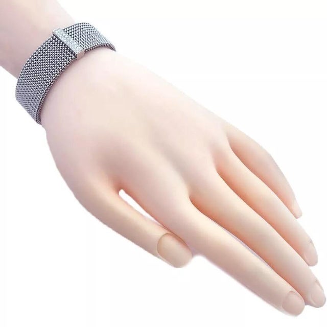 This chic fashionable bracelet is crafted from 18k white gold featuring an 18mm wide flexible stretch mesh band. The front...