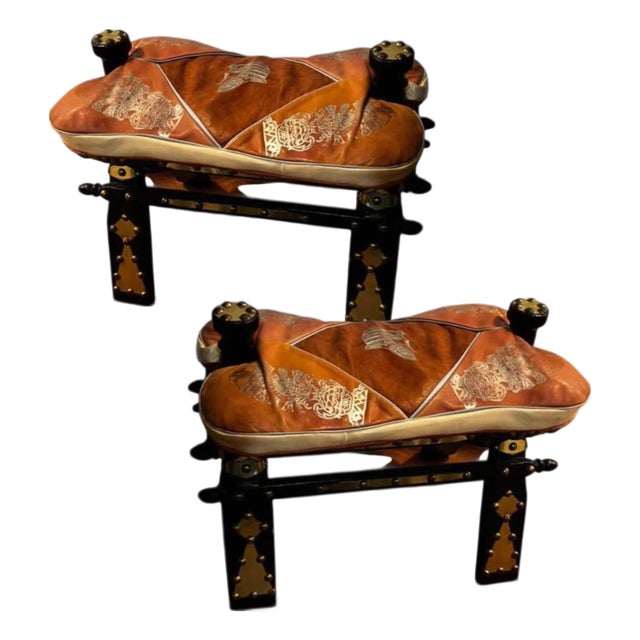 A Pair of Vintage Egyptian Camel Embossed Leather Cushions Saddle Stools With Embossed Egyptian Motifs & Decorative Brass Studs. For Sale