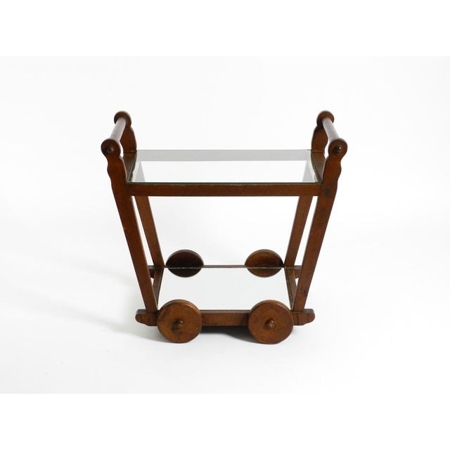 Beautiful serving and bar cart made of solid dark oak. Made in Netherlands in the 1930s. Great, unique design. Very...