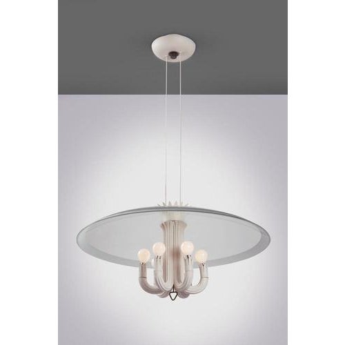 Suspended chandelier with a brass and lacquered metal frame, and a central body made of carved, white-lacquered wood....