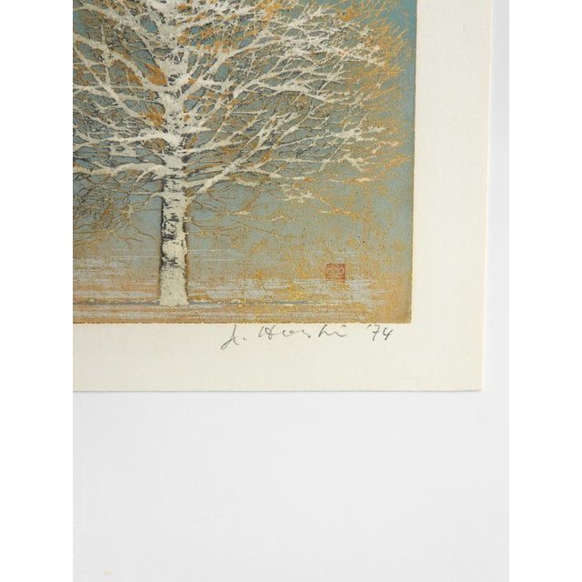 1974 turquoise, white and metallic gold woodblock print of tree by Joshi Hoshi (1913-1979) Japan. Signed and dated in...
