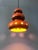 Mid-century German ceramic pendant lamp in beautiful red and brown tones. Light escapes elegantly from beneath the shade...