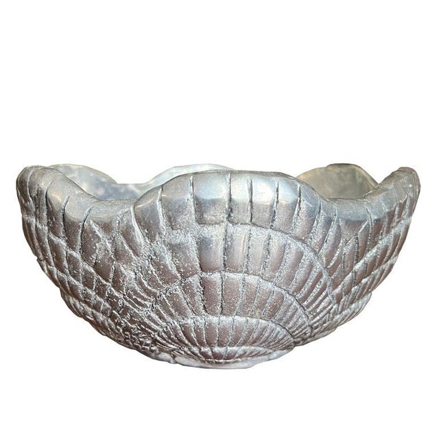 A silver metal Hollywood Regency serving bowl with a sea shell motif around the edges. This piece was made in Mexico and...