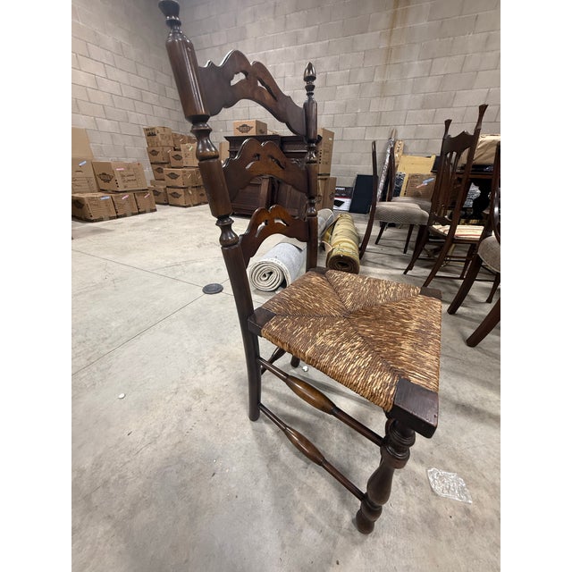 Vintage (likely antique) wood ladder chair with straw seat.